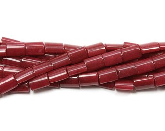 May include: Close-up of a strand of burgundy-colored, rectangular beads. The beads are smooth and glossy, with a slightly translucent appearance. The beads are strung together, creating a flowing, textured pattern against a white background. Ideal for jewelry making.