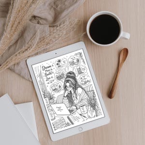 May include: A digital illustration on a tablet shows a woman with glasses working on a laptop, surrounded by thought bubbles with goals. A cup of coffee and a wooden spoon sit nearby on a light wood surface. The text "Dream it. Plan it. Build it. Live it."