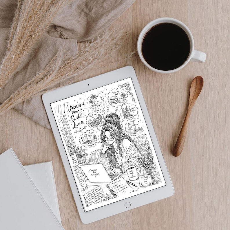 May include: A digital illustration on a tablet shows a woman with glasses working on a laptop, surrounded by thought bubbles with goals. A cup of coffee and a wooden spoon sit nearby on a light wood surface. The text "Dream it. Plan it. Build it. Live it."