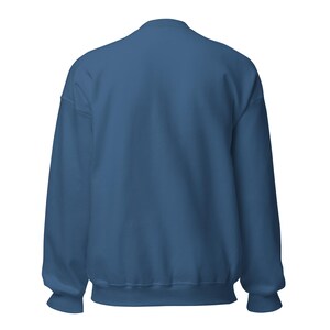 May include: A solid dark blue crewneck sweatshirt featuring long sleeves with ribbed cuffs and a ribbed hemline. The garment is shown from the back, displaying a plain, unpatterned fabric surface with a standard round neckline and set-in sleeves.
