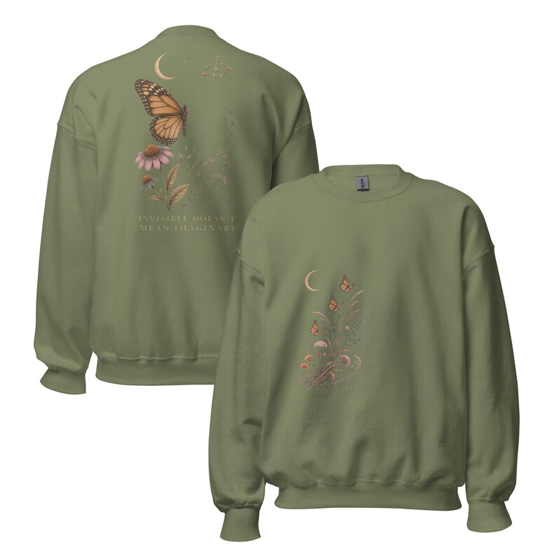 May include: An olive green crewneck sweatshirt featuring a graphic of a monarch butterfly, a crescent moon, and flowers on the back with the text "INVISIBLE DOESN'T MEAN IMAGINARY," and a smaller matching floral and butterfly graphic on the front chest.