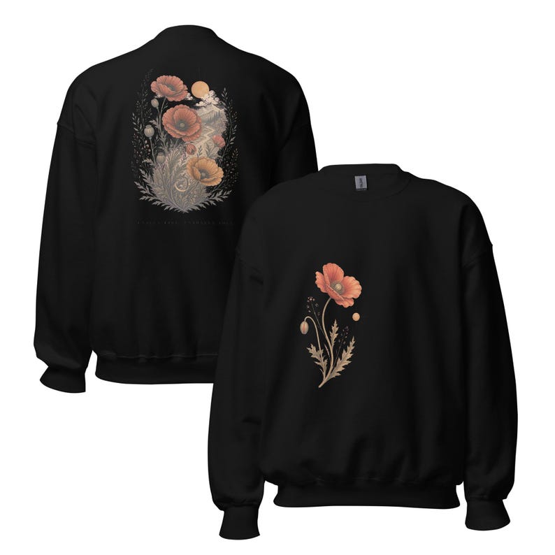 May include: A black crewneck sweatshirt featuring a single orange poppy flower graphic on the front. The back of the sweatshirt displays a larger, detailed illustration of multiple orange poppies, foliage, and a sun, all rendered in muted tones.
