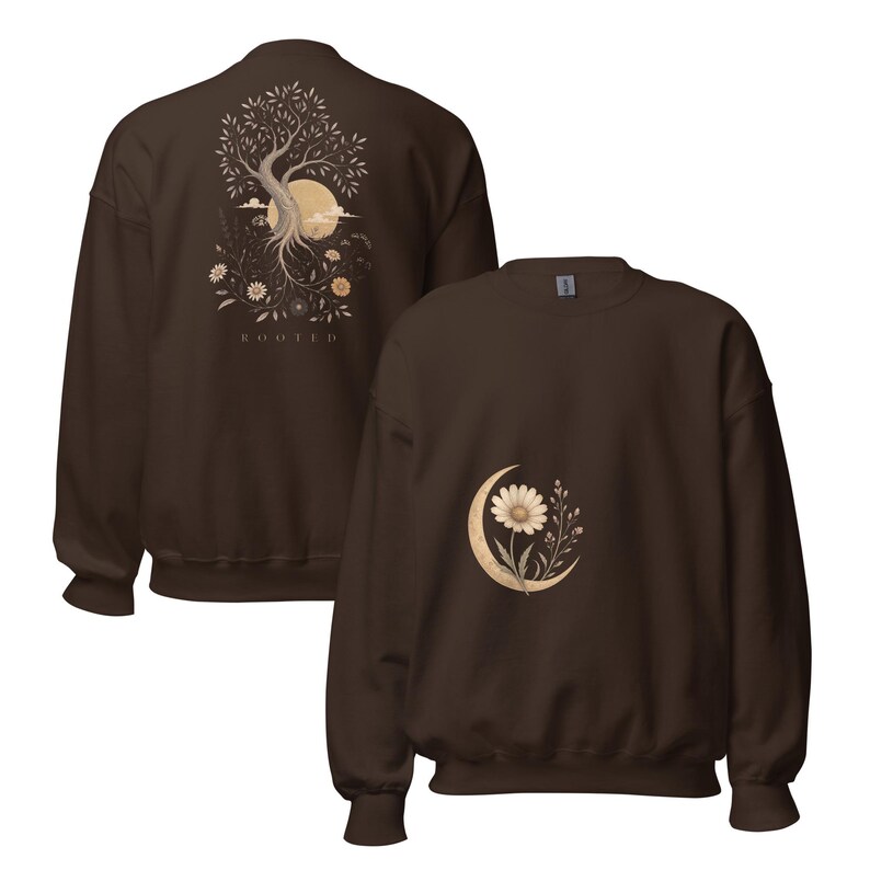 May include: A dark brown crewneck sweatshirt featuring a graphic on the back of a tree with roots, a sun, and the text "ROOTED" below it. The front of the sweatshirt displays a smaller graphic of a single daisy flower centered within a crescent moon.