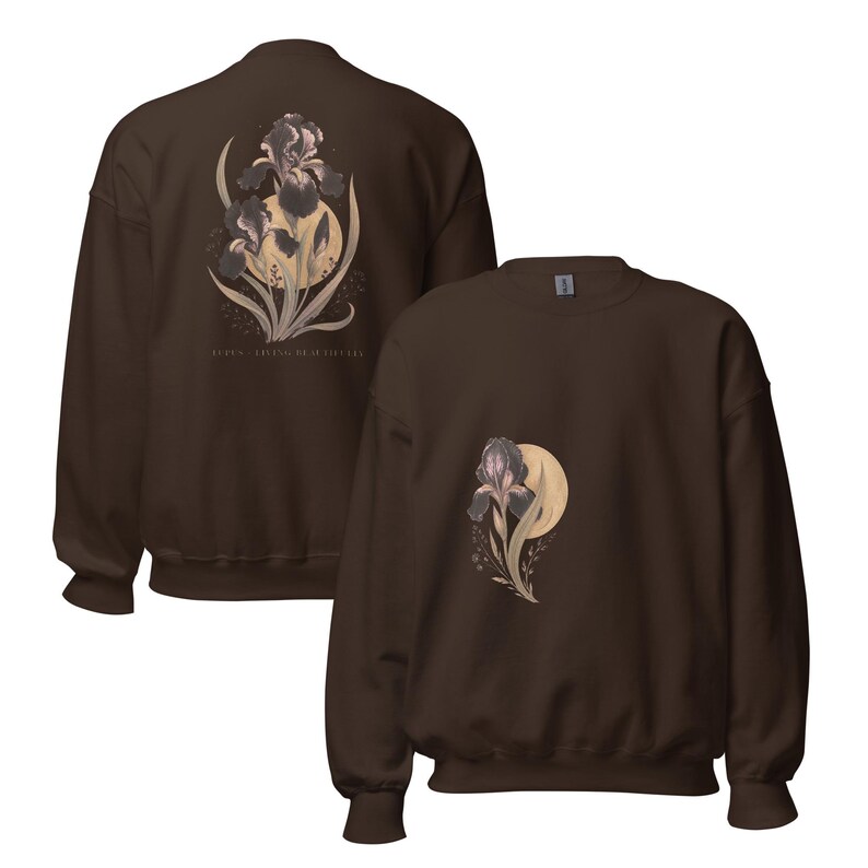 May include: A dark brown crewneck sweatshirt featuring a graphic of a dark purple iris flower layered over a pale yellow moon. The back of the sweatshirt displays a larger version of the same floral design with the text LUDEN - IRISAS DE FICATA.