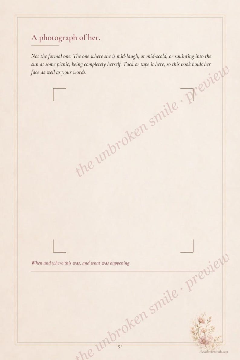 May include: A cream-colored journal page with the heading A photograph of her. It includes text instructions for attaching a photo, corner markers for placement, a line for writing when and where, and a small floral illustration in the bottom corner.