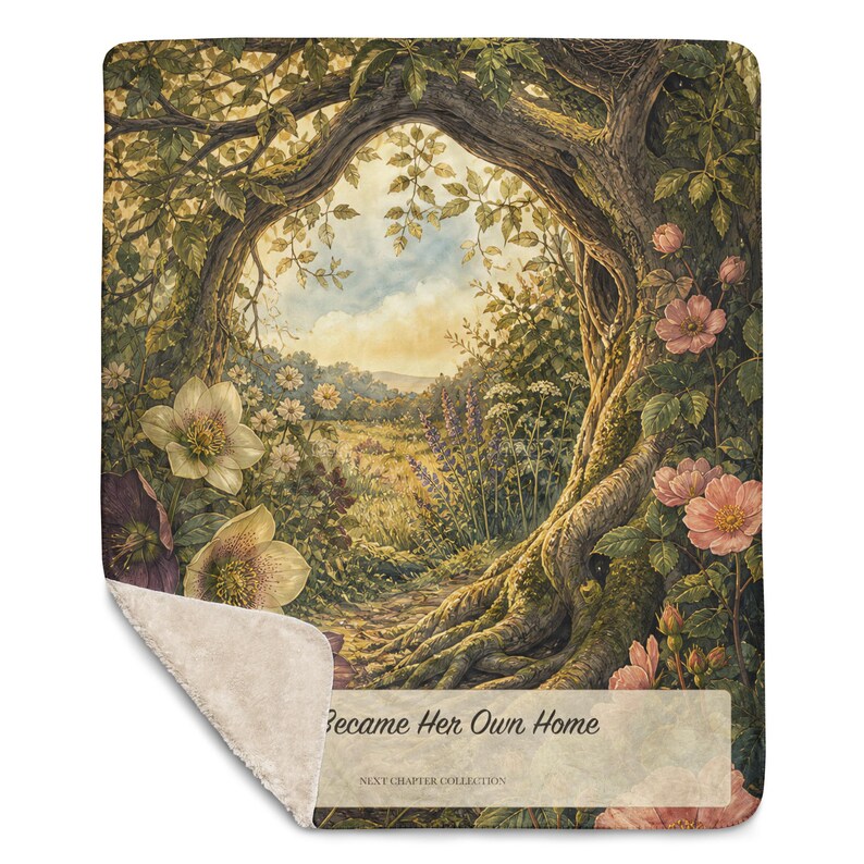 May include: A rectangular throw blanket with a sherpa fleece backing and a printed front featuring a forest scene with a large tree archway, pink roses, white flowers, and a meadow. The text reads "Became Her Own Home" and "NEXT CHAPTER COLLECTION".