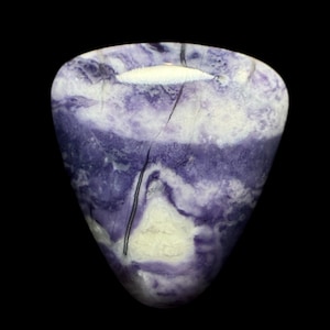 May include: A polished, teardrop-shaped stone with a blend of purple and white hues. The stone features a swirling pattern, with a prominent white area near the top and a dark vein running through it. The background is black.