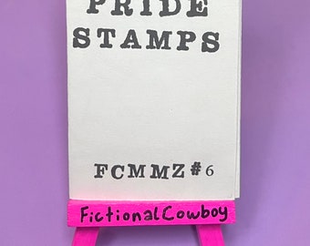 Könnte beinhalten: Eine weiße Karte mit dem Text "PRIDE STAMPS FCMMZ #6" auf einem rosa Staffelei mit dem Text "Fictional Cowboy" darauf.