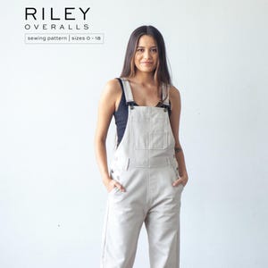May include: Light beige overalls with adjustable straps and a front pocket. The overalls are part of a sewing pattern, sizes 0-18, as indicated by the text "RILEY OVERALLS" and "sewing pattern | sizes 0-18". The model is wearing a black tank top.