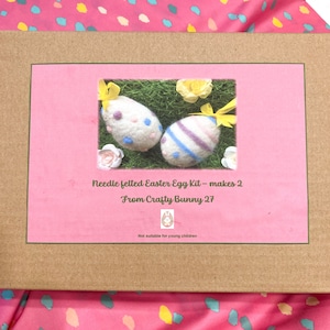 May include: A pink and brown box with a picture of two needle felted Easter eggs. The box says "Needle felted Easter Egg Kit - makes 2" and "From Crafty Bunny 27".