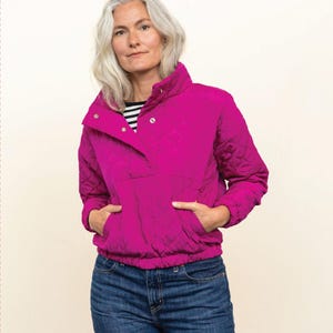 May include: A woman models a magenta quilted pullover with a high collar and pockets, paired with blue jeans. The image includes text that reads "The Pogonip Pullover" and "FRIDAY pattern co."
