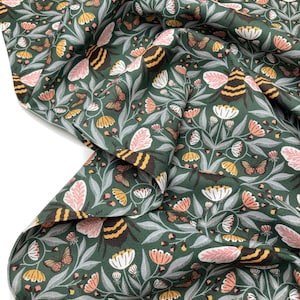 May include: Green fabric with a repeating pattern of pink flowers, yellow and brown bees, and orange butterflies.