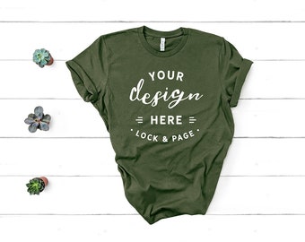 Download Free Bella Canvas 3001 Military Green Unisex T-Shirt Mockup Flat Lay Dark Green Garden Green Shirt Mock Up White Wooden Floor Backdrop PSD Template