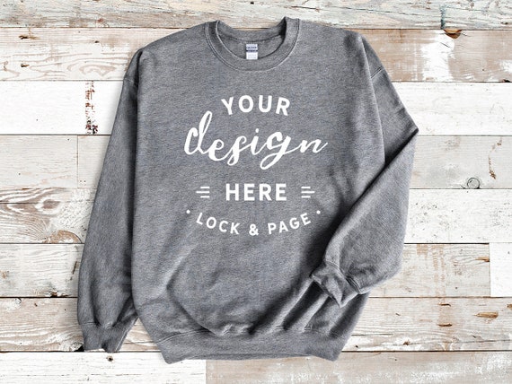 Heather Graphite Gildan 18000 Unisex Sweatshirt Mockup Jumper Flat Lay On Beach House Background