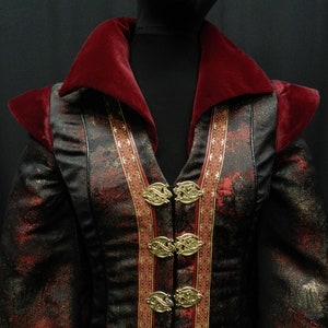 May include: A black and red jacket with gold accents and a large velvet collar. The jacket has a decorative pattern and multiple gold buttons.