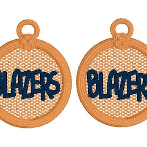 May include: Two embroidered circular patches with the word "BLAZERS" in navy blue. The patches have a tan border and a mesh-like background. Each patch has a loop at the top.