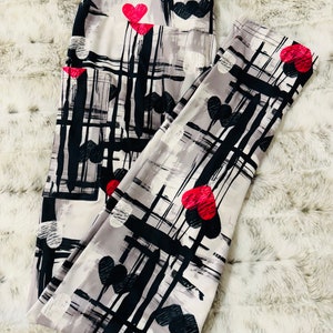 May include: Gray leggings with a black and white abstract pattern and red hearts.