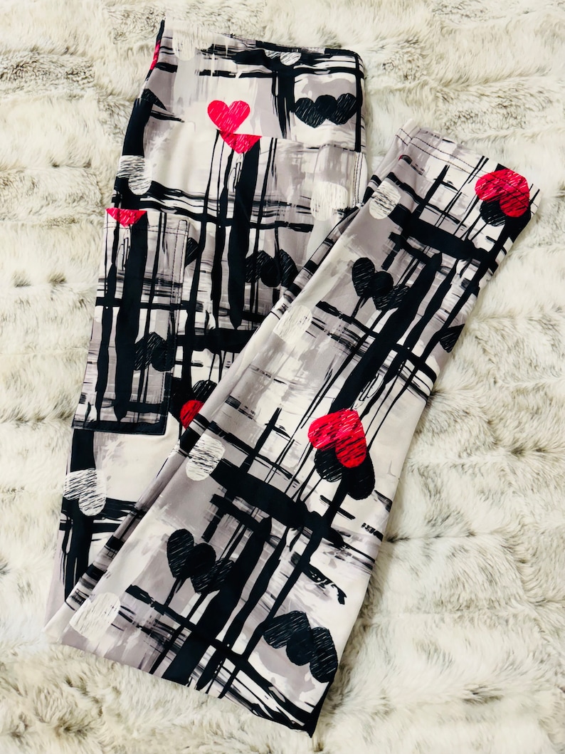 May include: Gray leggings with a black and white abstract pattern and red hearts.