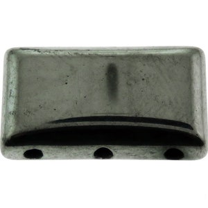 May include: A rectangular, metallic gray bead with rounded edges. The bead has three small holes along the bottom edge and a vertical indentation on the top surface. The bead's surface has a slightly textured appearance.