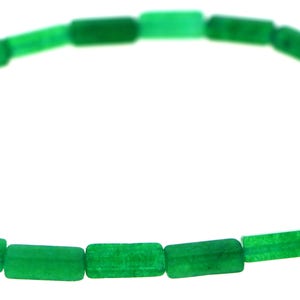 May include: A necklace composed of rectangular, vibrant green beads. The beads are strung together, forming a curved shape against a white background. The polished beads have a consistent size and shape, creating a simple, elegant design.