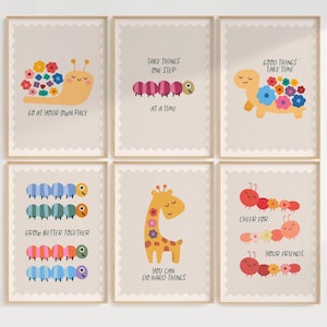 May include: A set of six framed wall art prints featuring light beige backgrounds and scalloped edges. Each print displays colorful cartoon animals including a snail, caterpillar, turtle, and giraffe with motivational text in black lettering.