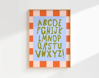 May include: A rectangular wall art print featuring a light blue central panel with the alphabet from A to Z and an exclamation point printed in olive green. The print is framed by a border of alternating orange and light pink checkered squares.