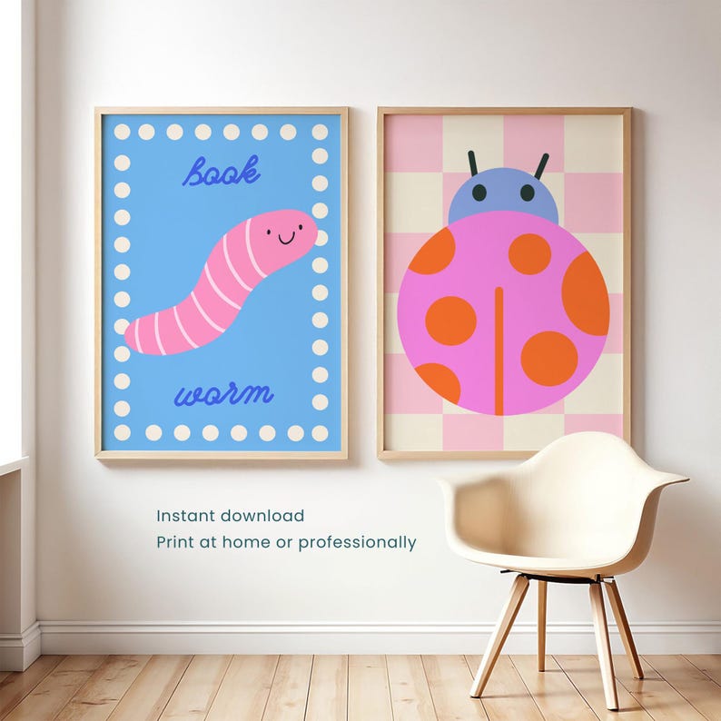 May include: Two framed wall art prints. The left print features a pink worm on a blue background with white dots and the text book worm. The right print displays a pink ladybug with orange spots on a pink and cream checkered background.