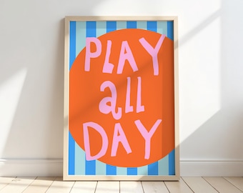 Puede incluir: Una impresión artística enmarcada con las palabras "PLAY ALL DAY" en letras rosas sobre un círculo naranja. El fondo presenta rayas verticales azules y celeste. El marco es de color madera clara.