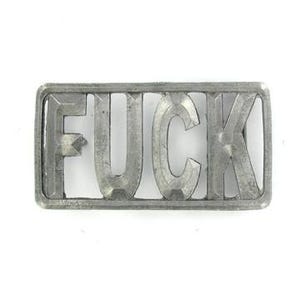 May include: A rectangular, silver-colored belt buckle with the word "FUCK" spelled out in bold, capital letters. The letters are cut out, creating negative space within the buckle's frame. The buckle has a slightly weathered appearance.