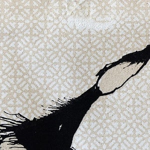 May include: Abstract black ink painting on a beige canvas with a white geometric pattern.