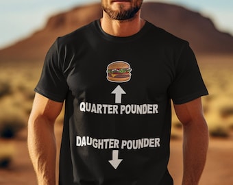 May include: Black t-shirt with a white graphic of a hamburger, an arrow pointing up with the text "Quarter Pounder" and an arrow pointing down with the text "Daughter Pounder".