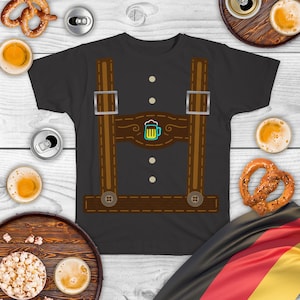 May include: A dark gray t-shirt with a brown leather lederhosen design. The design features suspenders, a beer stein, and stitching details.