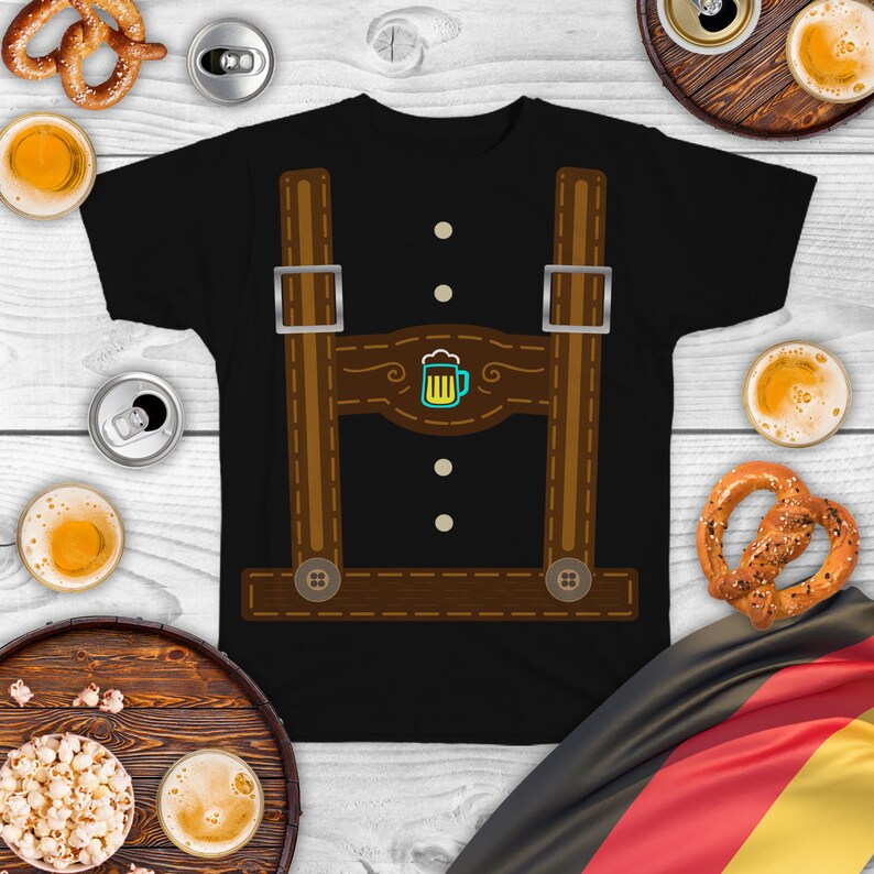 May include: Black t-shirt with a brown and white graphic of lederhosen suspenders and a beer stein. The graphic has a stitched look and includes three buttons.
