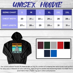 May include: Black unisex hoodie with a vintage-style graphic that says "Elevator is broken, use the steps". The hoodie has a drawstring hood and a kangaroo pocket. A size chart is included with measurements in inches.