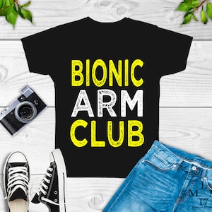 May include: Black t-shirt with the text "Bionic Arm Club" in white letters with a yellow outline.