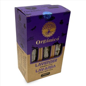 May include: A rectangular cardboard box containing three lavender smudge sticks visible through clear windows. The packaging is purple and brown with gold text reading Org&aacute;nico, Lavender Handmade Sticks, and Lavanda Hecho a Mano Palos.