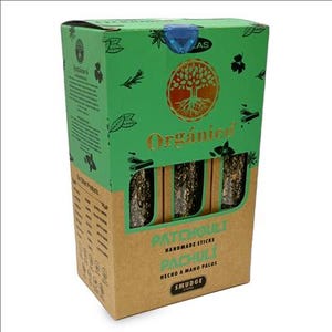 May include: A box of "Org&aacute;nica" patchouli handmade smudge sticks. The box is green and tan with a tree logo and botanical illustrations. The sticks are visible through a window in the box, and the text "Patchouli" is printed on the front.