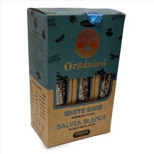 May include: A box of "Org&aacute;nico" white sage smudge sticks. The box is teal and brown with gold lettering and a tree of life design. The text "WHITE SAGE" and "SALVIA BLANCA" are visible on the front of the box.