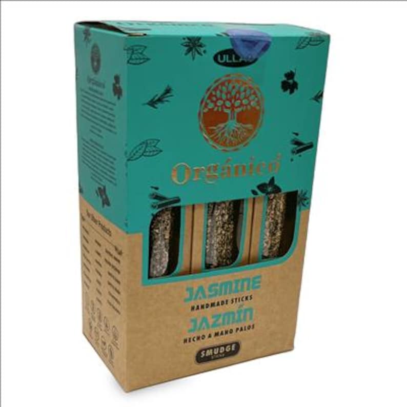 May include: A box of jasmine handmade smudge sticks. The box is teal and brown with the word "Organico" and a tree logo. The box has a window showing the sticks inside. The text "Jasmine Handmade Sticks Jazm&iacute;n" is printed on the front.