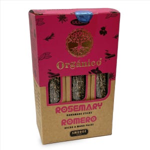 May include: A rectangular cardboard box with a pink top and brown bottom containing three rosemary smudge sticks. The box features a gold tree logo, the text Org&aacute;nico, Rosemary Handmade Sticks, Romero Hecho a Mano Palos, and Smudge Sticks.