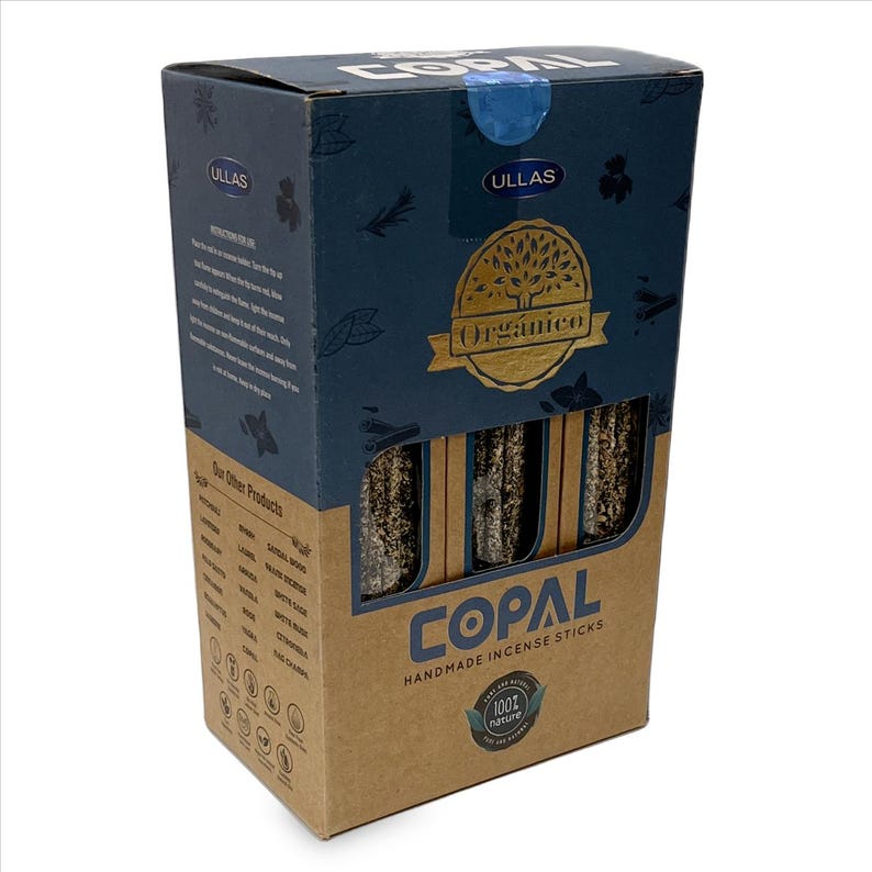May include: A box of Copal handmade incense sticks. The box is a mix of brown and dark blue with the word "Copal" in large white letters. The box also has the words "Organico" and "100% nature" printed on it.