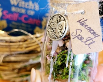 May include: A small glass jar with a pink wax seal and a brown paper tag that reads "Memory Spell". The jar contains dried flowers, moss, and pink Himalayan salt.
