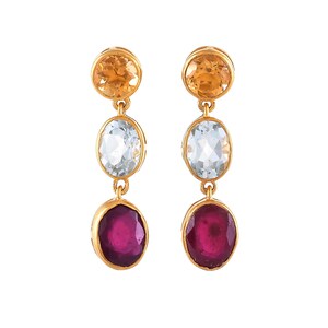 May include: A pair of gold-toned drop earrings. Each earring features three gemstones: a round, orange-yellow stone at the top, an oval, light blue stone in the middle, and an oval, deep red stone at the bottom. The gemstones are connected by small gold links.