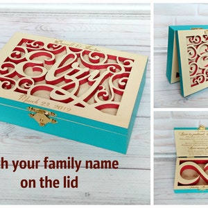 May include: A teal wooden box with a cutout design on the lid. The cutout design features the words "Love is patient, love is kind" and an infinity symbol. The box is open and the inside is lined with a cream-colored fabric. The box is perfect for storing jewelry or other small items.