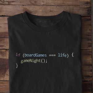 May include: Black t-shirt with a code snippet that reads "if (boardGames === life) { gameNight(); }" in colourful text.