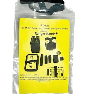 May include: A clear plastic bag with a black drawstring closure containing 17 black rubber bands. The bag has a yellow label with the text "17 Count", "Qty 17: 1/2" Tall by 1-7/8" Diameter (3" long when laid flat)", "NGE61972 TM", "Ranger Bands®", and "(all dimensions +/- 0.1250)". The label also includes the text "Made out of EPDM Rubber for outstanding heat, UV, and saltwater resistance. ALL BANDS ARE EXTRUDED EPDM RUBBER 101 uses. rangerband1.com".
