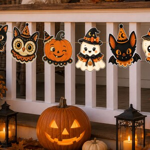 May include: A Halloween garland featuring six hanging cutouts: a black cat, an owl, a winking pumpkin, a ghost, a bat, and a skull, all wearing orange and black witch hats. The figures are decorated with orange ruffles and suspended on a string.