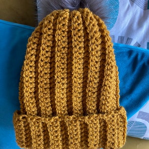 Hand made woollen beanie with detachable faux fur pom pom
