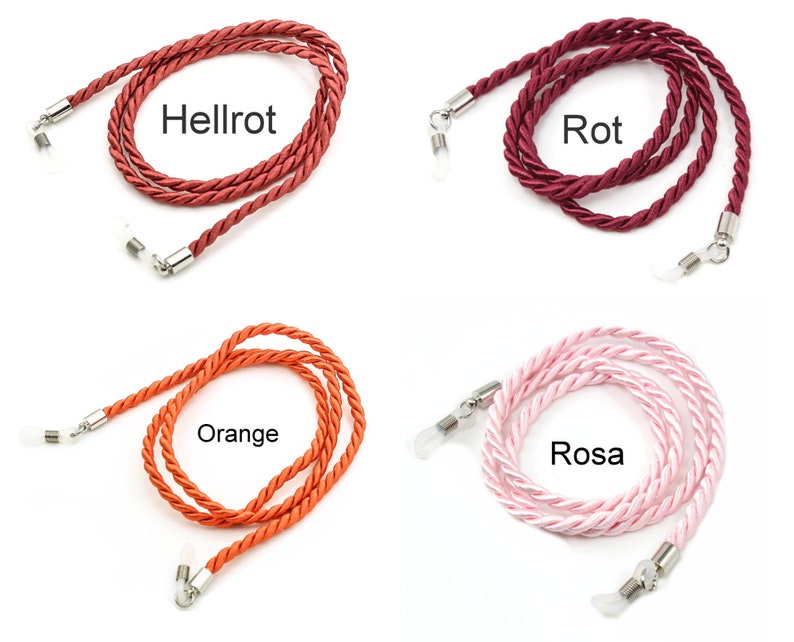 May include: Four different colors of braided cord eyeglass holders. The colors are orange, pink, red, and dark red. The cords are made of a soft, braided material and have metal clasps on each end.