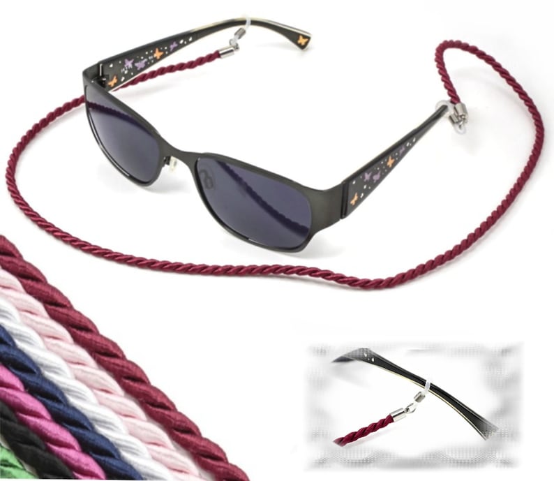 May include: Burgundy braided cord eyeglasses retainer with a pair of black sunglasses with butterfly designs. The sunglasses have dark lenses. The image also shows a variety of colors of the same cord.